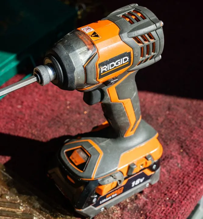 Jeff's cordless drill sitting on a red work mat.